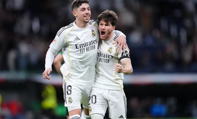 Real Madrid's Federico Valverde, left, celebrates after scoring his side's second goal during a Spanish La Liga soccer match between Real Madrid and Elche CF, in Madrid, Saturday, March 14, 2026. (AP Photo/Manu Fernandez)
