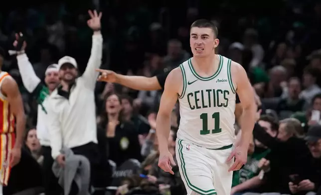 Boston Celtics guard Payton Pritchard (11) celebrates after hitting a 3-point basket against the Atlanta Hawks during the second half of an NBA basketball game, Friday, March 27, 2026, in Boston. (AP Photo/Charles Krupa)