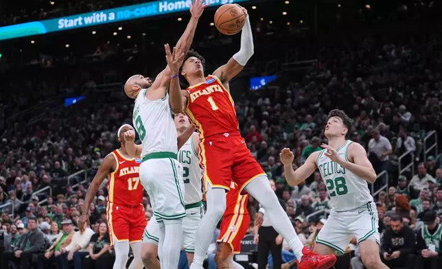 Atlanta Hawks forward Jalen Johnson drives to the basket against the Boston Celtics center during the second half of an NBA basketball game, Friday, March 27, 2026, in Boston. (AP Photo/Charles Krupa)