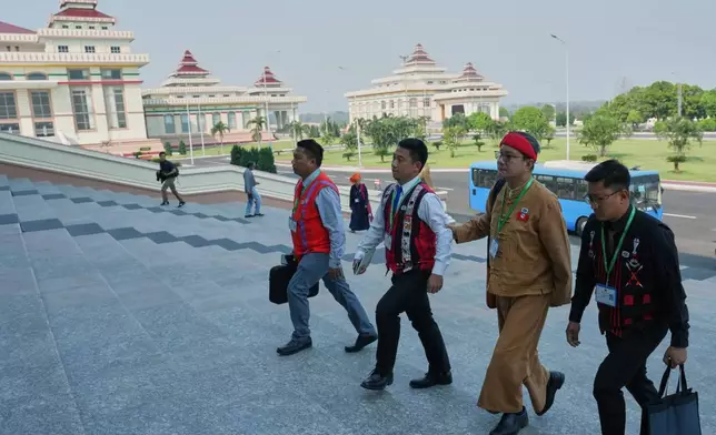 CORRECTS THE YEAR - Myanmar lawmakers arrive to attend a session at Lower House parliament in Naypyitaw, Myanmar, Monday, March 16, 2026. (AP Photo/Aung Shine Oo)
