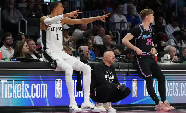 San Antonio Spurs forward Victor Wembanyama (1) reacts during the second half of an NBA basketball game against the Miami Heat, Monday, March 23, 2026, in Miami. (AP Photo/Lynne Sladky)