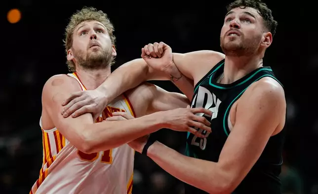 Atlanta Hawks center Jock Landale (31) and Portland Trail Blazers center Donovan Clingan (23) vie for a rebound during the first half of an NBA basketball game, Sunday, March 1, 2026, in Atlanta. (AP Photo/Mike Stewart)