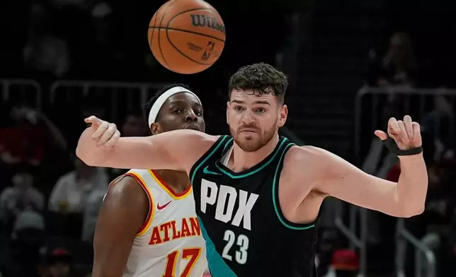Portland Trail Blazers center Donovan Clingan (23) loses the ball against Atlanta Hawks forward Onyeka Okongwu (17) during the first half of an NBA basketball game, Sunday, March 1, 2026, in Atlanta. (AP Photo/Mike Stewart)