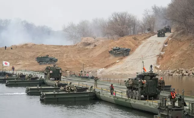 U.S. Army's armored vehicles cross a floating bridge on the Imjin River during a joint river-crossing exercise between South Korea and the United States as a part of the Freedom Shield military exercise in Yeoncheon, South Korea, Saturday, March 14, 2026. (AP Photo/Ahn Young-joon)