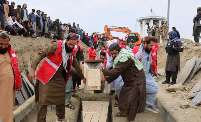 Coffins are placed in a grave during a second mass funeral for victims of an airstrike on a drug rehabilitation center earlier this month, in Kabul, Afghanistan, Thursday, March 26, 2026. (AP Photo/Siddiqullah Alizai)