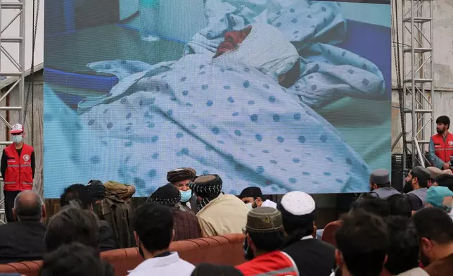 A video showing an alleged survivor of a late-Monday airstrike at a drug rehabilitation hospital is displayed on a screen during a press conference at the site of the strike in Kabul, Afghanistan, Tuesday, March 17, 2026. (AP Photo/Siddiqullah Alizai)