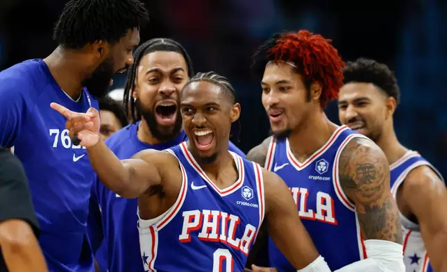 Philadelphia 76ers guard Tyrese Maxey (0) celebrates with his teammates after scoring against the Charlotte Hornets during the second half of an NBA basketball game in Charlotte, N.C., Saturday, March 28, 2026. (AP Photo/Nell Redmond)