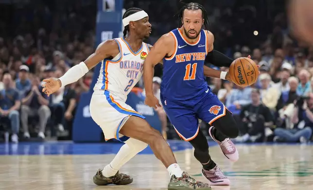New York Knicks guard Jalen Brunson (11) drives against Oklahoma City Thunder guard Shai Gilgeous-Alexander (2) during the first half of an NBA basketball game Sunday, March 29, 2026, in Oklahoma City. (AP Photo/Nate Billings)