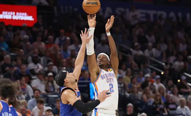 Oklahoma City Thunder guard Shai Gilgeous-Alexander (2) shoots over New York Knicks guard Josh Hart, left, during the second half of an NBA basketball game Sunday, March 29, 2026, in Oklahoma City. (AP Photo/Nate Billings)