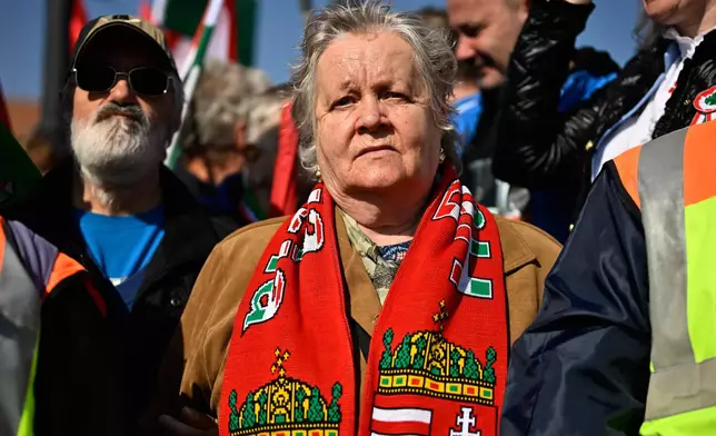 Supporters of Prime Minister Viktor Orban take part in a march in Budapest, Hungary, Sunday, March 15, 2026. (AP Photo/Denes Erdos)