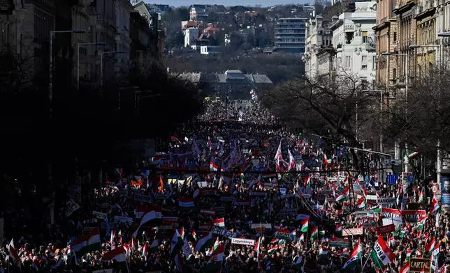 Supporters of Prime Minister Viktor Orban march through Budapest, Hungary, Sunday, March 15, 2026. (AP Photo/Denes Erdos)