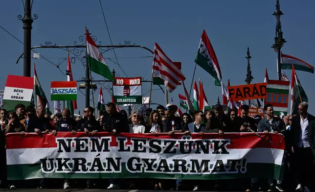 Supporters of Prime Minister Viktor Orban attend a pro-Orban march in Budapest, Hungary, Sunday, March 15, 2026. (AP Photo/Denes Erdos)