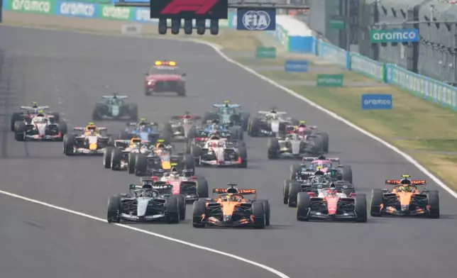 McLaren driver Oscar Piastri of Australia, second left, leads the field at the start of the Japanese Formula One Grand Prix at Suzuka in central Japan, Sunday, March 29, 2026. (AP Photo/Eugene Hoshiko)