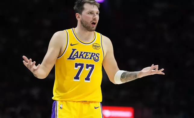 Los Angeles Lakers guard Luka Doncic (77) argues a call during the second half of an NBA basketball game against the Miami Heat, Thursday, March 19, 2026, in Miami. (AP Photo/Lynne Sladky)