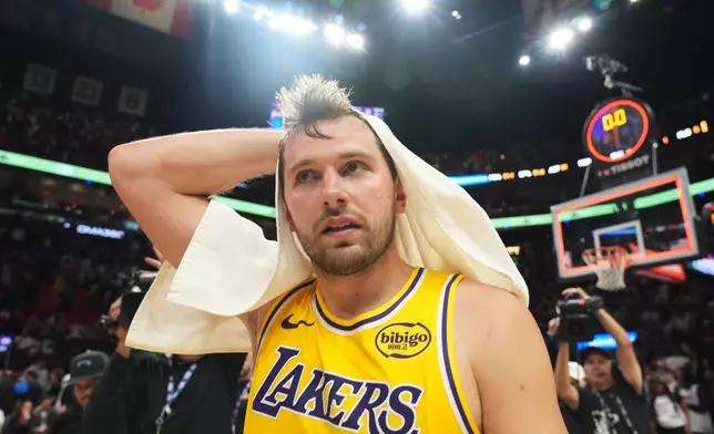 Los Angeles Lakers guard Luka Doncic walks off the court after the Lakers defeated the Miami Heat in an NBA basketball game, Thursday, March 19, 2026, in Miami. (AP Photo/Lynne Sladky)