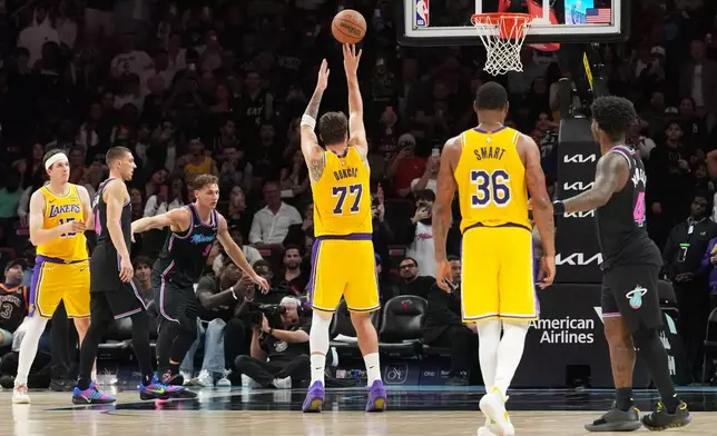 Los Angeles Lakers guard Luka Doncic (77) shoots a free throw to score sixty points during the second half of an NBA basketball game against the Miami Heat, Thursday, March 19, 2026, in Miami. (AP Photo/Lynne Sladky)