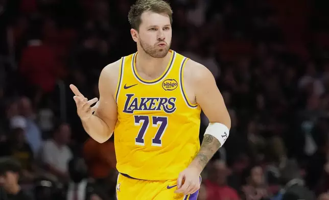 Los Angeles Lakers guard Luka Doncic (77) reacts after scoring during the second half of an NBA basketball game against the Miami Heat, Thursday, March 19, 2026, in Miami. (AP Photo/Lynne Sladky)