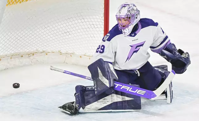 Minnesota Frost goaltender Nicole Hensley is scored against by Montreal Victoire's Maggie Flaherty during first-period PWHL hockey game action in Laval, Quebec, Sunday, March 1, 2026. (Graham Hughes/The Canadian Press via AP)