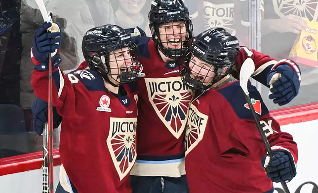 Montreal Victoire's Laura Stacey (7) celebrates with teammates Marie-Philip Poulin (29) and Maggie Flaherty (91) after scoring against the Minnesota Frost's during third-period PWHL hockey game action in Laval, Quebec, Sunday, March 1, 2026. (Graham Hughes/The Canadian Press via AP)