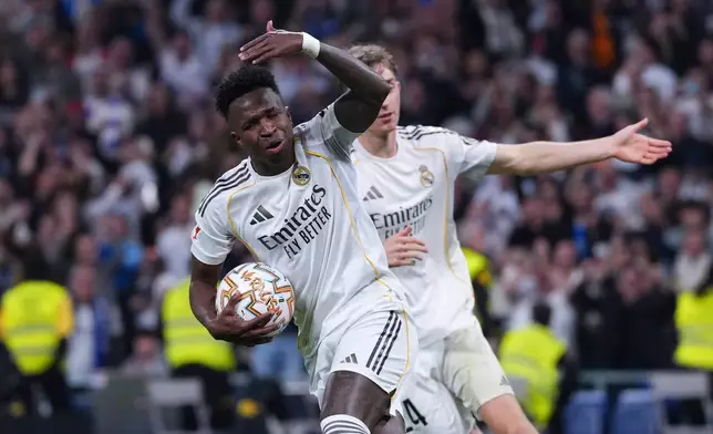 Real Madrid's Vinicius Junior celebrates after scoring his side's first goal the Spanish La Liga soccer match between Real Madrid and Atletico Madrid in Madrid, Spain, Sunday, March 22, 2026. (AP Photo/Manu Fernandez)