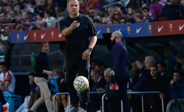 Barcelona's head coach Hansi Flick returns the ball during a La Liga soccer match between Barcelona and Rayo Vallecano in Barcelona, Spain, Sunday, March 22, 2026. (AP Photo/Joan Monfort)