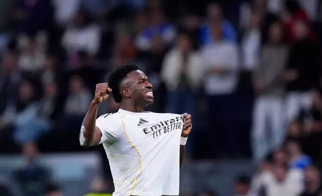 Real Madrid's Vinicius Junior celebrates after scoring his side's third goal during the Spanish La Liga soccer match between Real Madrid and Atletico Madrid in Madrid, Spain, Sunday, March 22, 2026. (AP Photo/Manu Fernandez)