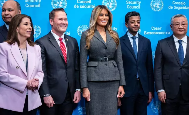 First lady Melania Trump takes a photo with a group of UN Diplomats before she presides over the United Nations Security Council on Iran and the recent attacks by U.S. and Israel at United Nations headquarters, Monday, March 2, 2026. (AP Photo/Angelina Katsanis)