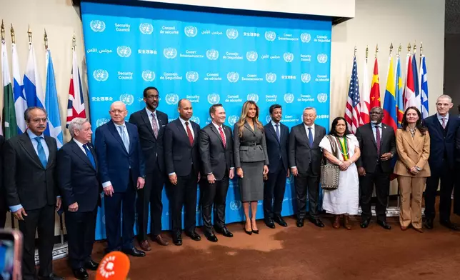 First lady Melania Trump takes a photo with a group of UN Diplomats before she presides over the United Nations Security Council on Iran and the recent attacks by U.S. and Israel at United Nations headquarters, Monday, March 2, 2026. (AP Photo/Angelina Katsanis)