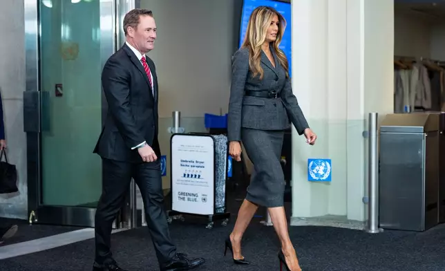 Melania Trump, first lady of the United States, arrives with U.S. Ambassador Mike Waltz, to preside over a United Nations Security Council meeting at United Nations headquarters, Monday, March 2, 2026. (AP Photo/Angelina Katsanis)