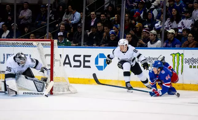 New York Rangers right wing Gabe Perreault (94) shoots during the first period of an NHL hockey game against the Los Angeles Kings, Monday, March 16, 2026, in New York. (AP Photo/Angelina Katsanis)