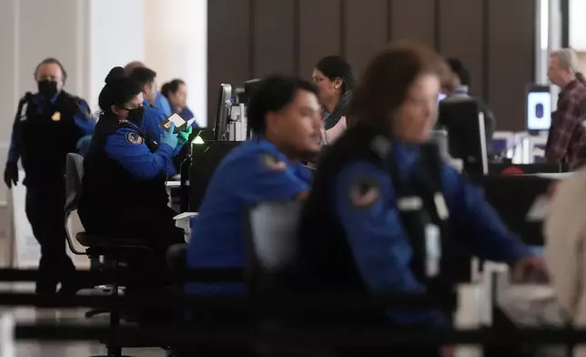 Covenant Aviation Security Private Security Services agents check in passengers at a security gate at San Francisco International Airport in San Francisco, Friday, Feb. 27, 2026. (AP Photo/Jeff Chiu)