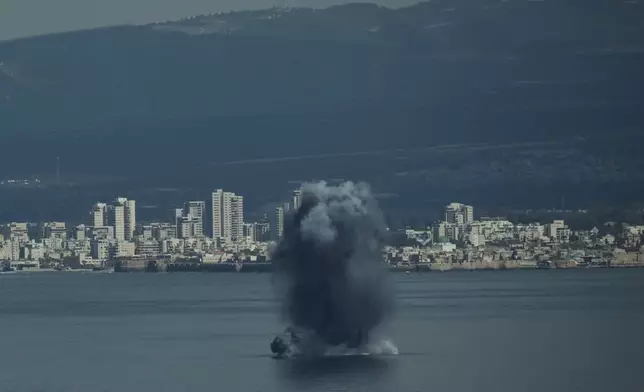An incoming projectile explodes over the water as Israel issues a nationwide alert following its strikes on Iran, in Haifa Bay, northern Israel, Saturday, Feb. 28, 2026. (AP Photo/Leo Correa)