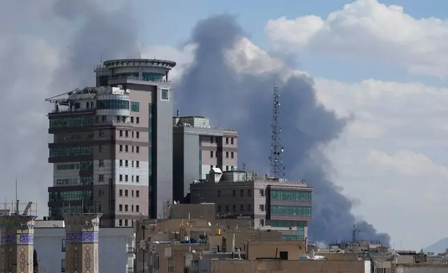 Smoke rises up after a strike in Tehran, Iran, Sunday, March 1, 2026. (AP Photo/Vahid Salemi)