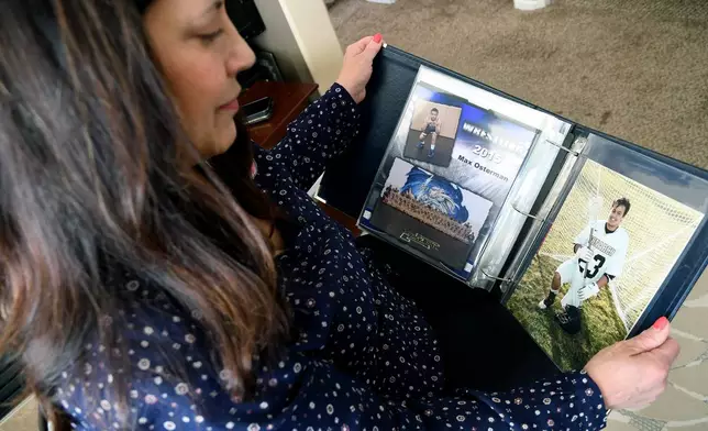 Kim Osterman shows photos of her son Max, who she says died after taking fentanyl he bought from a dealer on Snapchat, in her living room in Thornton, Colo., on Thursday, March 26, 2026. (AP Photo/Thomas Peipert)