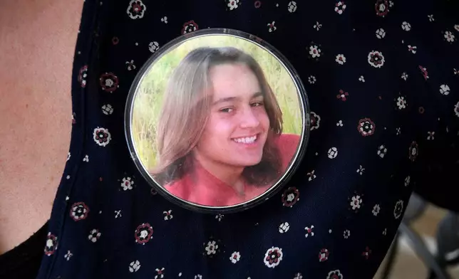 A photo of Max Osterman, whose mother says he died after taking fentanyl he bought from a dealer on Snapchat, is worn on his mother's blouse at her home in Thornton, Colo., on Thursday, March 26, 2026. (AP Photo/Thomas Peipert)