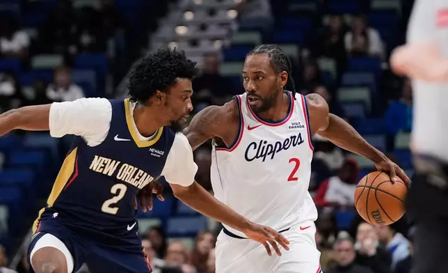 Los Angeles Clippers forward Kawhi Leonard (2) drives to the basket against New Orleans Pelicans forward Herbert Jones (2) in the first half of an NBA basketball game, Wednesday, March 18, 2026, in New Orleans. (AP Photo/Gerald Herbert)