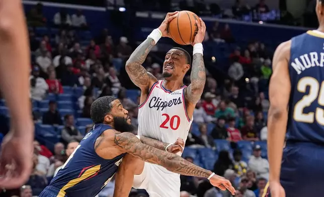 Los Angeles Clippers forward John Collins (20) goes to the basket against New Orleans Pelicans guard Saddiq Bey in the first half of an NBA basketball game, Wednesday, March 18, 2026, in New Orleans. (AP Photo/Gerald Herbert)