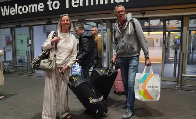 Lindsay Elvidge and husband Ric, from Somerset, arrive at Terminal 4 of London Heathrow Airport on a flight from Abu Dhabi in the United Arab Emirates, Monday, March 2, 2026. (Yui Mok/PA via AP)