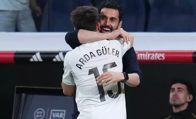 Real Madrid's Arda Guler celebrates with Real Madrid's head coach Alvaro Arbeloa after scoring his side's fourth goal during a Spanish La Liga soccer match between Real Madrid and Elche CF, in Madrid, Saturday, March 14, 2026. (AP Photo/Manu Fernandez)