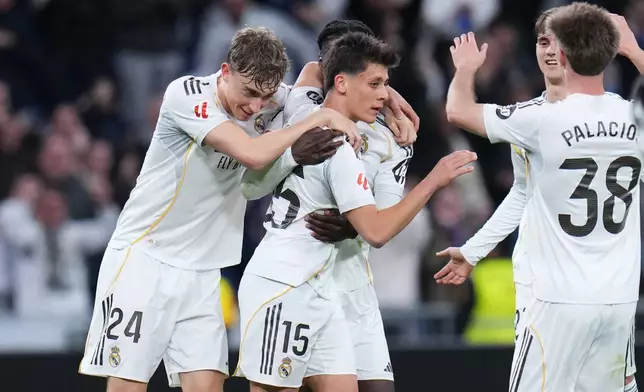 Real Madrid's Arda Guler, center, celebrates after scoring his side's fourth goal during a Spanish La Liga soccer match between Real Madrid and Elche CF, in Madrid, Saturday, March 14, 2026. (AP Photo/Manu Fernandez)