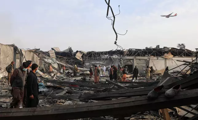 Residents and volunteers inspect the site of a late-Monday airstrike at a drug rehabilitation hospital in Kabul, Afghanistan, Tuesday, March 17, 2026. (AP Photo/Siddiqullah Alizai)