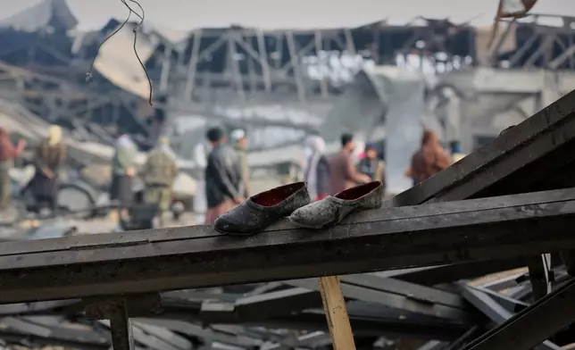 Residents and rescue workers inspect the site of a late-Monday airstrike at a drug rehabilitation hospital in Kabul, Afghanistan, Tuesday, March 17, 2026. (AP Photo/Siddiqullah Alizai)