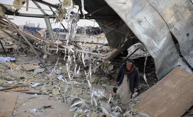 A rescue worker inspects the site of a late-Monday airstrike at a drug rehabilitation hospital in Kabul, Afghanistan, Tuesday, March 17, 2026. (AP Photo/Siddiqullah Alizai)