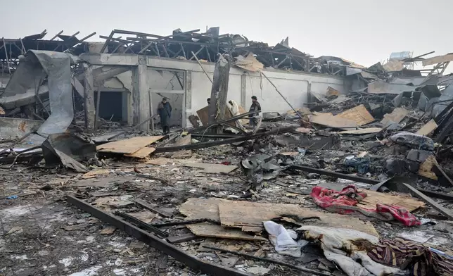 Residents and rescue workers inspect the site of a late-Monday airstrike at a drug rehabilitation hospital in Kabul, Afghanistan, Tuesday, March 17, 2026. (AP Photo/Siddiqullah Alizai)