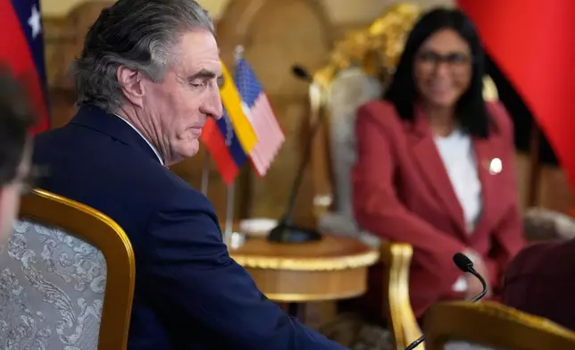 Venezuela's acting President Delcy Rodriguez, behind, and U.S. Interior Secretary Doug Burgum meet Miraflores presidential palace in Caracas, Venezuela, Wednesday, March 4, 2026. (AP Photo/Ariana Cubillos)