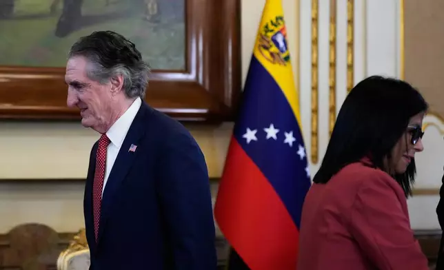 Venezuela's acting President Delcy Rodriguez, right, and U.S. Interior Secretary Doug Burgum arrive for a meeting at Miraflores presidential palace in Caracas, Venezuela, Wednesday, March 4, 2026. (AP Photo/Ariana Cubillos)