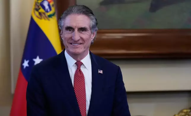 U.S. Interior Secretary Doug Burgum smiles during a meeting with Venezuela's acting President Delcy Rodriguez at Miraflores presidential palace in Caracas, Venezuela, Wednesday, March 4, 2026. (AP Photo/Ariana Cubillos)