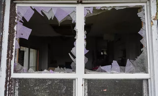 A window is damaged in the aftermath of a powerful storm that ripped through the area a day earlier in Kankakee, Ill., Wednesday, March 11, 2026. (AP Photo/Nam Y. Huh)