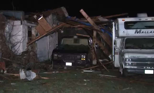 CORRECTS STATE TO INDIANA - Debris covers vehicles after a severe storm passed the area in in Kankakee County, Illinois., late Tuesday, March 10, 2026. (WLS-TV via AP)