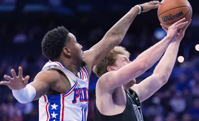 Brooklyn Nets' Danny Wolf, right, goes up to shoot against Philadelphia 76ers' Justin Edwards during the first half of an NBA basketball game Saturday, March 14, 2026, in Philadelphia. (AP Photo/Matt Rourke)